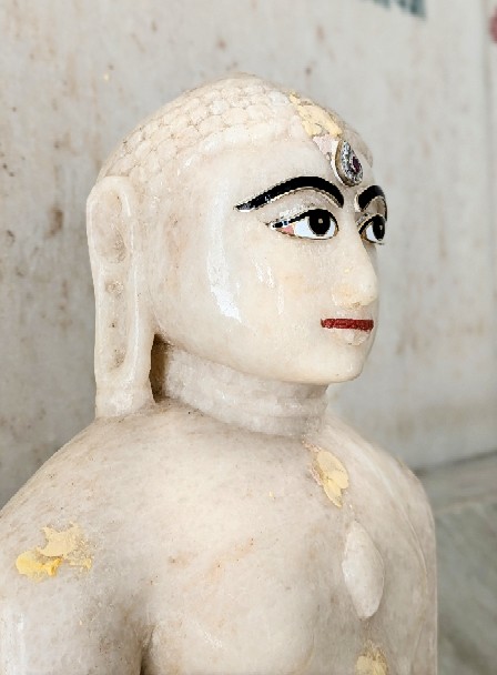 Close view of a serene marble idol inside the temple